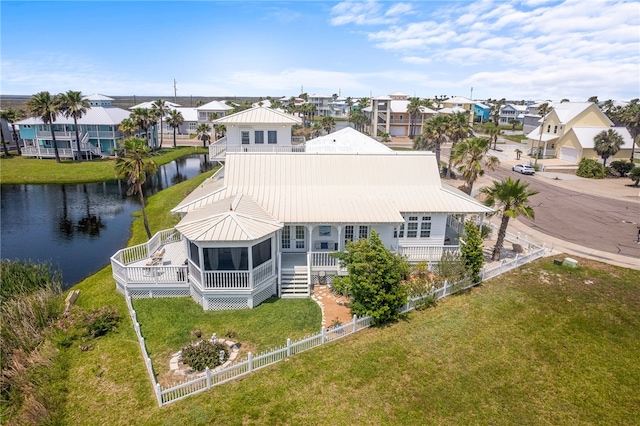 4820 Sanibel Ln, Port Aransas, TX 78373 - rear view of property featuring a fenced backyard, a residential view, metal roof, and a sunroom