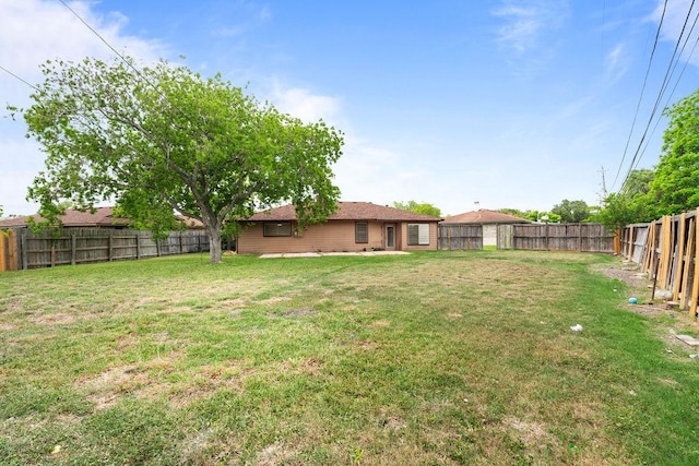 view of yard with a fenced backyard