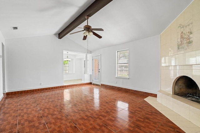 unfurnished living room featuring visible vents, a fireplace, baseboards, lofted ceiling with beams, and a ceiling fan