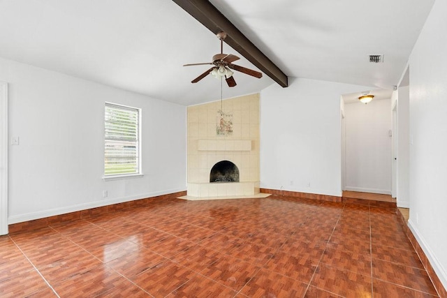 unfurnished living room featuring ceiling fan, visible vents, a tiled fireplace, baseboards, and lofted ceiling with beams