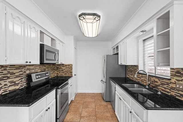 kitchen with a sink, decorative backsplash, appliances with stainless steel finishes, and white cabinetry