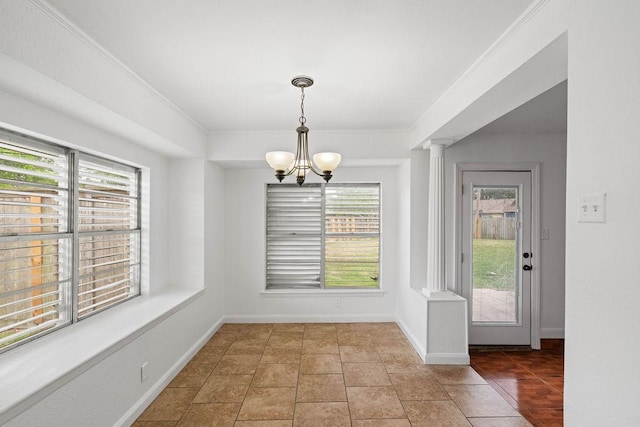 unfurnished dining area featuring plenty of natural light, baseboards, and an inviting chandelier