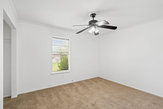unfurnished room with crown molding, baseboards, ceiling fan, and light carpet