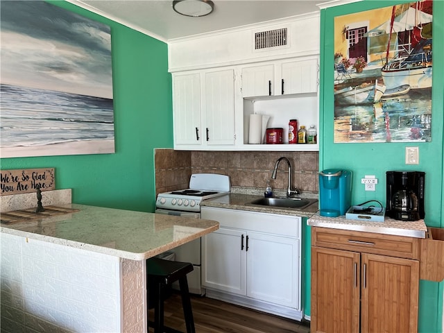 kitchen featuring white cabinets, white range, sink, and dark hardwood / wood-style floors