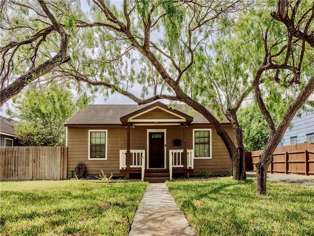 112 E 6th St, Bishop, TX 78343 - bungalow-style house featuring a porch, a front yard, and fence
