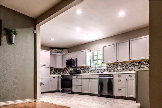112 E 6th St, Bishop, TX 78343 - kitchen with light countertops, stainless steel appliances, gray cabinets, and tasteful backsplash