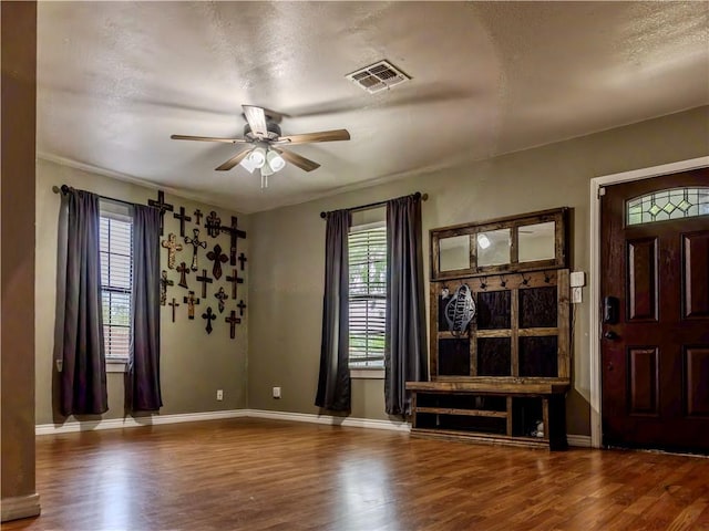 112 E 6th St, Bishop, TX 78343 - entrance foyer featuring visible vents, wood finished floors, ceiling fan, and a textured ceiling