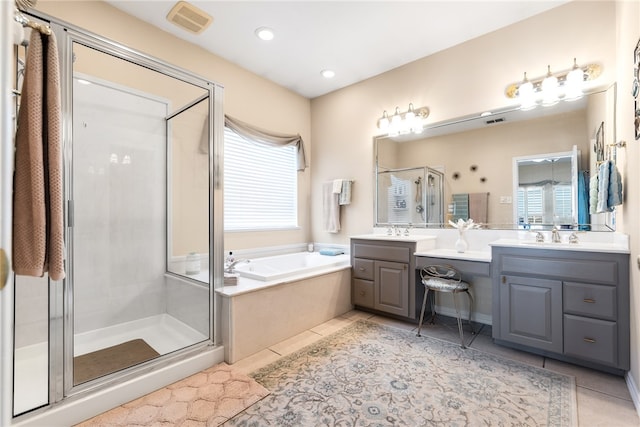 bathroom featuring independent shower and bath, vanity, and tile patterned flooring