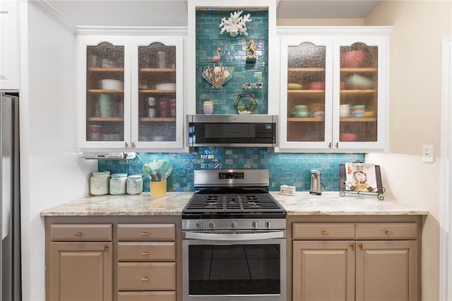 bar featuring appliances with stainless steel finishes and backsplash