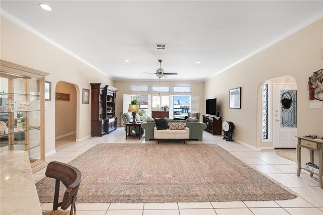 living room featuring ceiling fan, light tile patterned floors, and ornamental molding