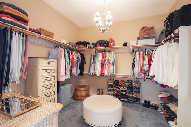 spacious closet with an inviting chandelier and carpet floors