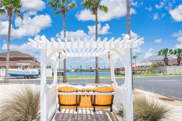 view of patio / terrace featuring a water view and a pergola