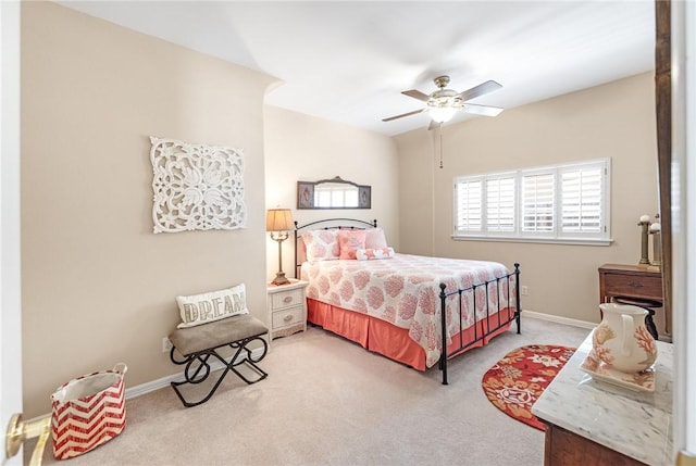 carpeted bedroom featuring baseboards and ceiling fan