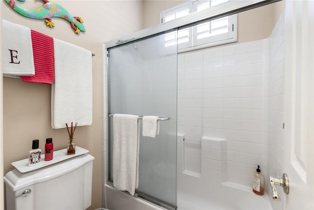full bathroom featuring enclosed tub / shower combo and toilet