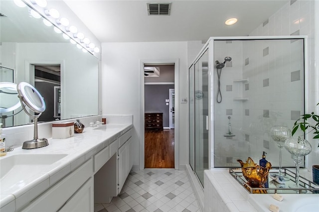 419 Peerman Pl, Corpus Christi, TX 78411 - bathroom featuring a shower stall, double vanity, tile patterned flooring, a bathtub, and recessed lighting