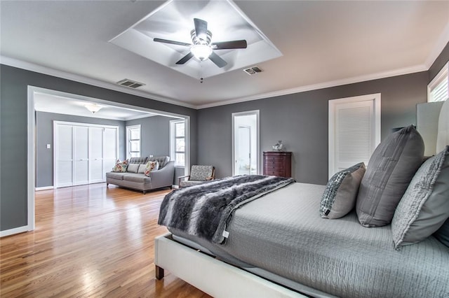 419 Peerman Pl, Corpus Christi, TX 78411 - bedroom featuring light wood-type flooring, ornamental molding, a tray ceiling, baseboards, and a ceiling fan