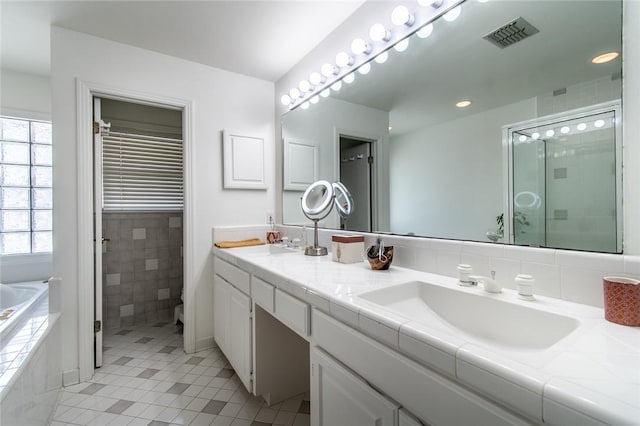 419 Peerman Pl, Corpus Christi, TX 78411 - full bath with double vanity, tile patterned flooring, a bath, toilet, and an enclosed shower