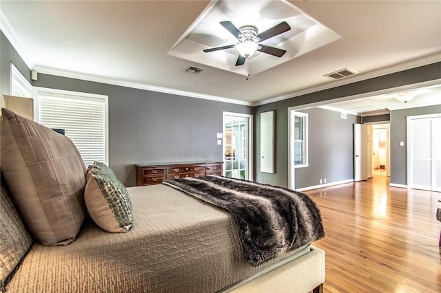 419 Peerman Pl, Corpus Christi, TX 78411 - bedroom featuring wood finished floors, a tray ceiling, ornamental molding, ceiling fan, and baseboards