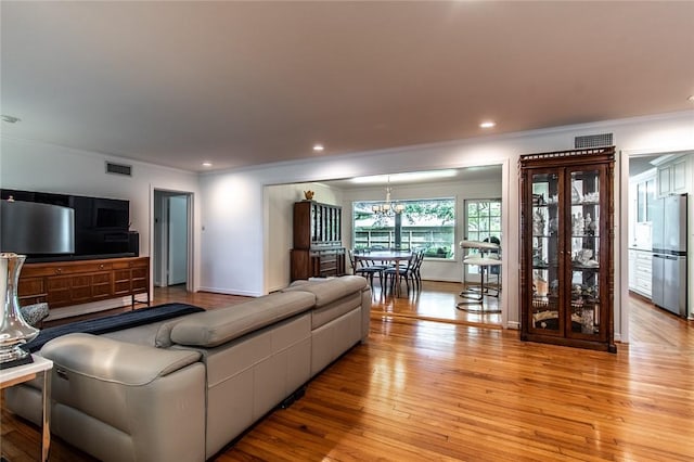 419 Peerman Pl, Corpus Christi, TX 78411 - living room with ornamental molding, light wood-type flooring, a chandelier, baseboards, and recessed lighting