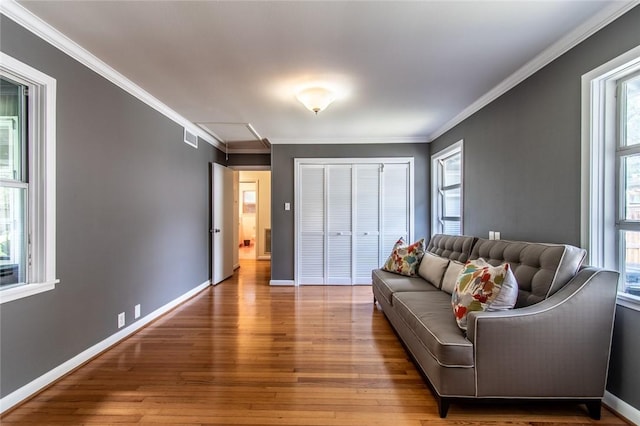 419 Peerman Pl, Corpus Christi, TX 78411 - living room with healthy amount of natural light, wood-type flooring, crown molding, and attic access