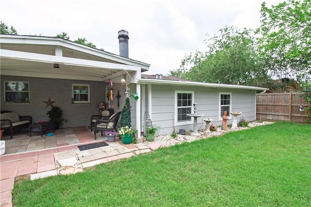 905 E Randall St, Beeville, TX 78102 - back of property with a patio area, fence, and a yard