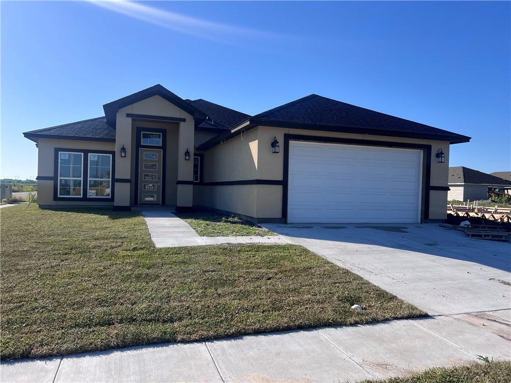 6202 Olivia St, Corpus Christi, TX 78415 - ranch-style home with a garage, concrete driveway, a front yard, stucco siding, and roof with shingles