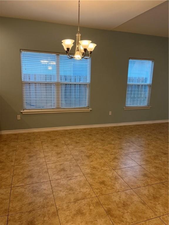 unfurnished room featuring baseboards, light tile patterned floors, and an inviting chandelier