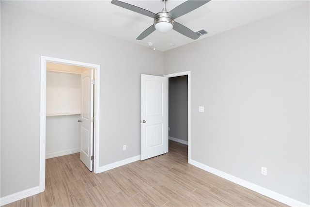 6214 Sadie St, Corpus Christi, TX 78415 - unfurnished bedroom with light wood-style floors, a spacious closet, a ceiling fan, and a closet