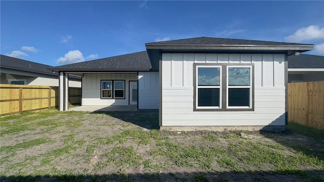 6214 Sadie St, Corpus Christi, TX 78415 - back of house featuring board and batten siding, a fenced backyard, and a shingled roof
