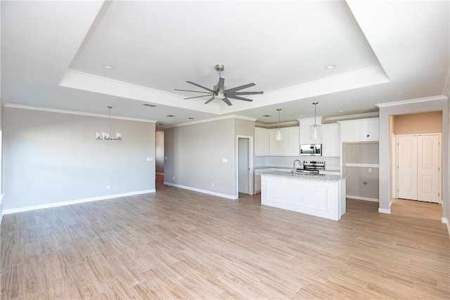 6214 Sadie St, Corpus Christi, TX 78415 - unfurnished living room with a tray ceiling, ceiling fan, a chandelier, light wood-style floors, and recessed lighting