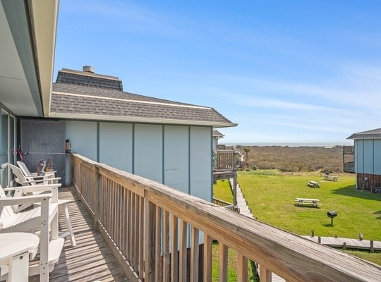 wooden deck featuring a yard