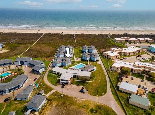 birds eye view of property featuring a view of the beach and a water view