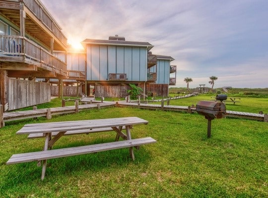 view of property's community featuring a lawn and a rural view