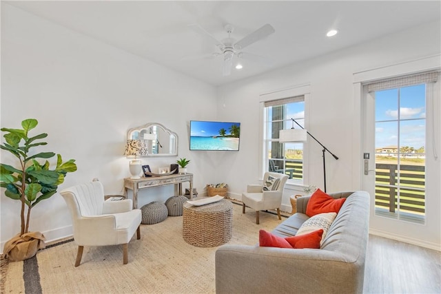 living area featuring recessed lighting, ceiling fan, baseboards, and wood finished floors