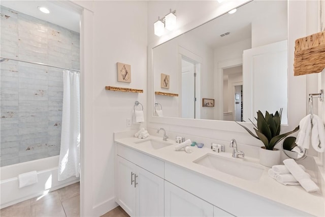 bathroom with tile patterned floors, double vanity, shower / bath combo, and a sink