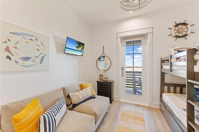 living area with baseboards and light wood finished floors