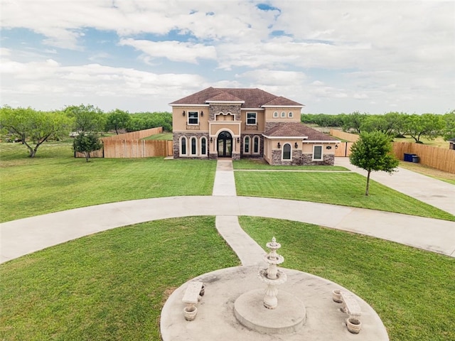 mediterranean / spanish house with a front yard