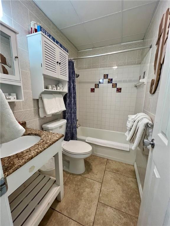 full bathroom featuring tile patterned flooring, tile walls, toilet, shower / bath combination with curtain, and vanity