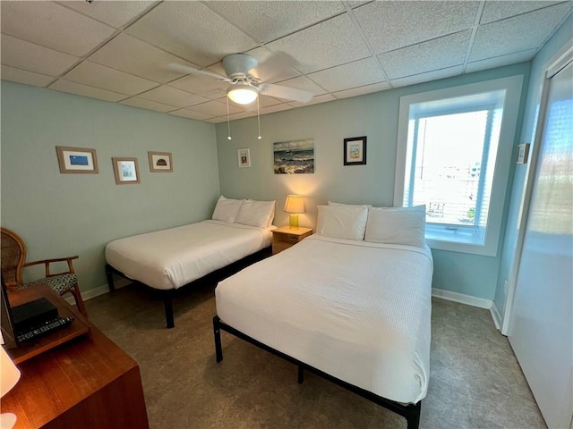 bedroom featuring a drop ceiling and ceiling fan