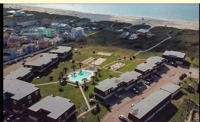 birds eye view of property with a water view and a view of the beach