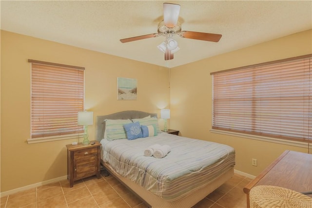 122 Palm Dr, Rockport, TX 78382 - tiled bedroom with baseboards and ceiling fan
