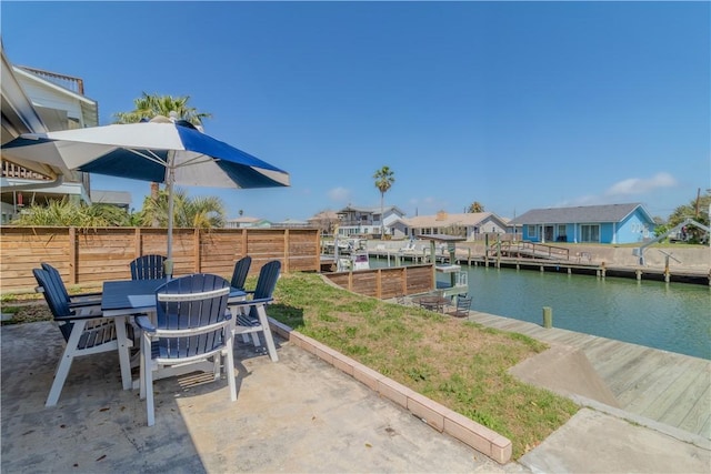 122 Palm Dr, Rockport, TX 78382 - exterior space with a water view, a residential view, outdoor dining area, a dock, and a patio