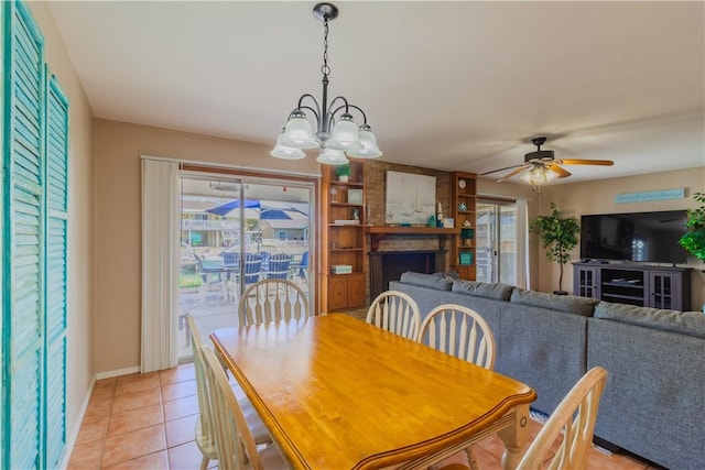 122 Palm Dr, Rockport, TX 78382 - dining space with a wealth of natural light, baseboards, light tile patterned flooring, and ceiling fan with notable chandelier