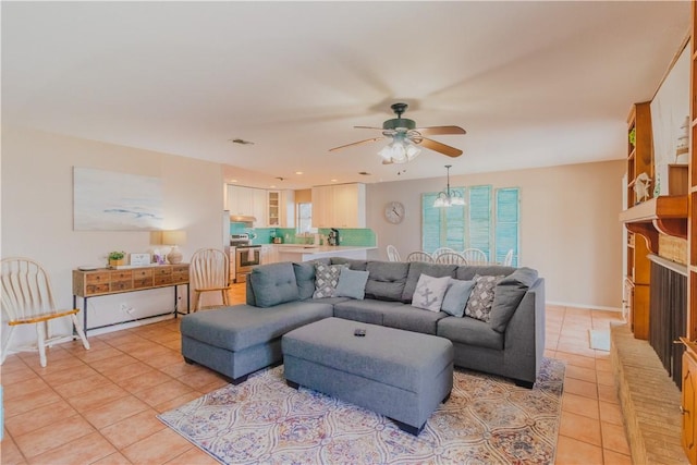 122 Palm Dr, Rockport, TX 78382 - living area with light tile patterned floors, visible vents, baseboards, and a ceiling fan