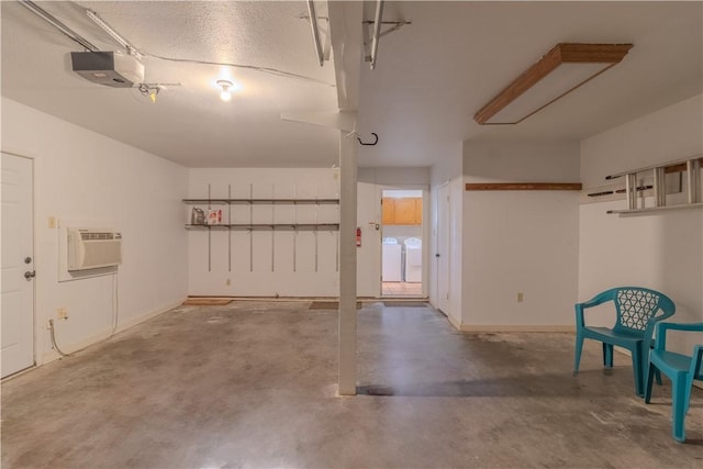 122 Palm Dr, Rockport, TX 78382 - garage with a garage door opener, independent washer and dryer, a wall mounted air conditioner, and baseboards