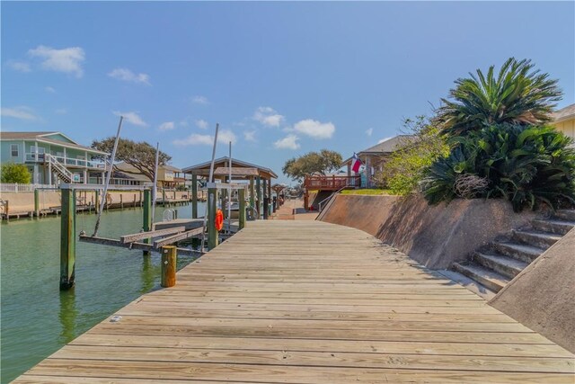 122 Palm Dr, Rockport, TX 78382 - dock area with boat lift, a residential view, and a water view