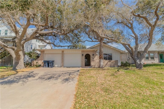 122 Palm Dr, Rockport, TX 78382 - view of front of house featuring brick siding, driveway, a front yard, and a garage