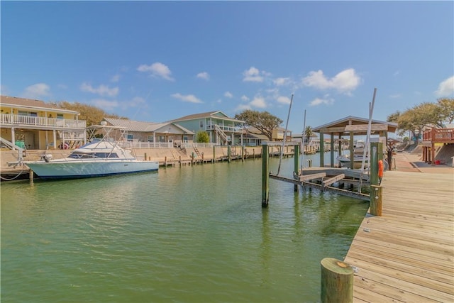 122 Palm Dr, Rockport, TX 78382 - view of dock with a residential view, a water view, and boat lift