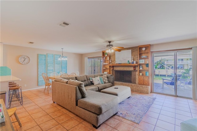 122 Palm Dr, Rockport, TX 78382 - living room with light tile patterned floors, plenty of natural light, ceiling fan with notable chandelier, and built in features