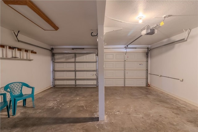 122 Palm Dr, Rockport, TX 78382 - garage with baseboards and a garage door opener
